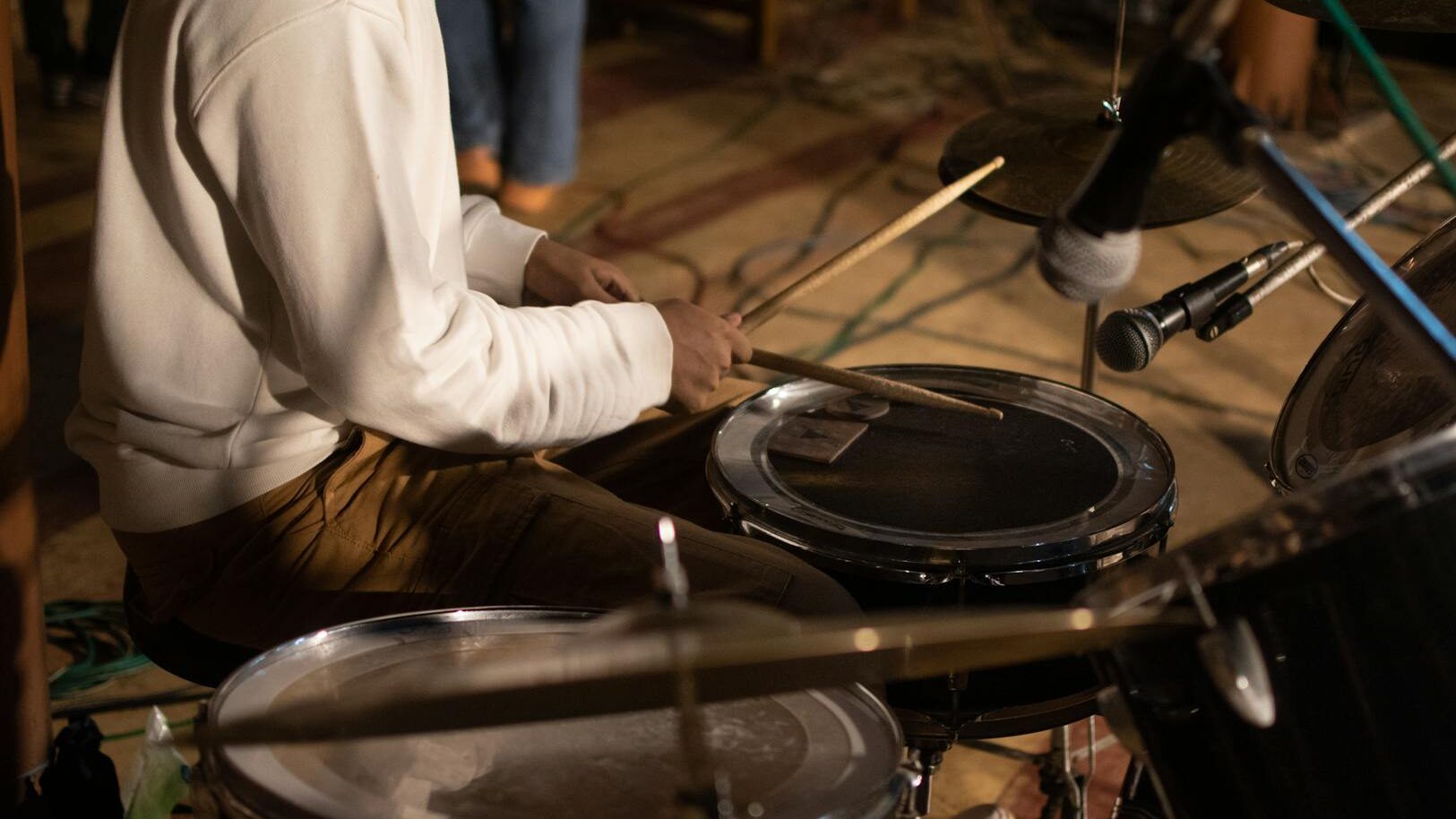 man playing on drums in the studio