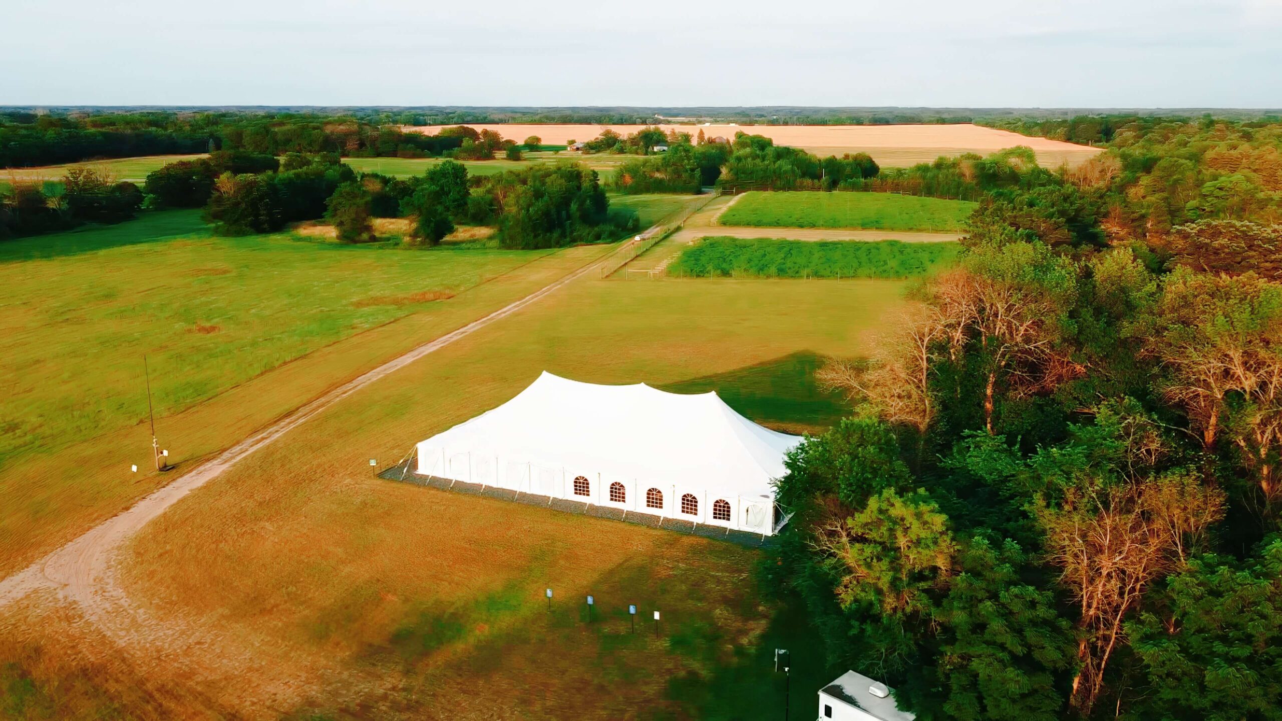 arial view of white tent venue next to winery