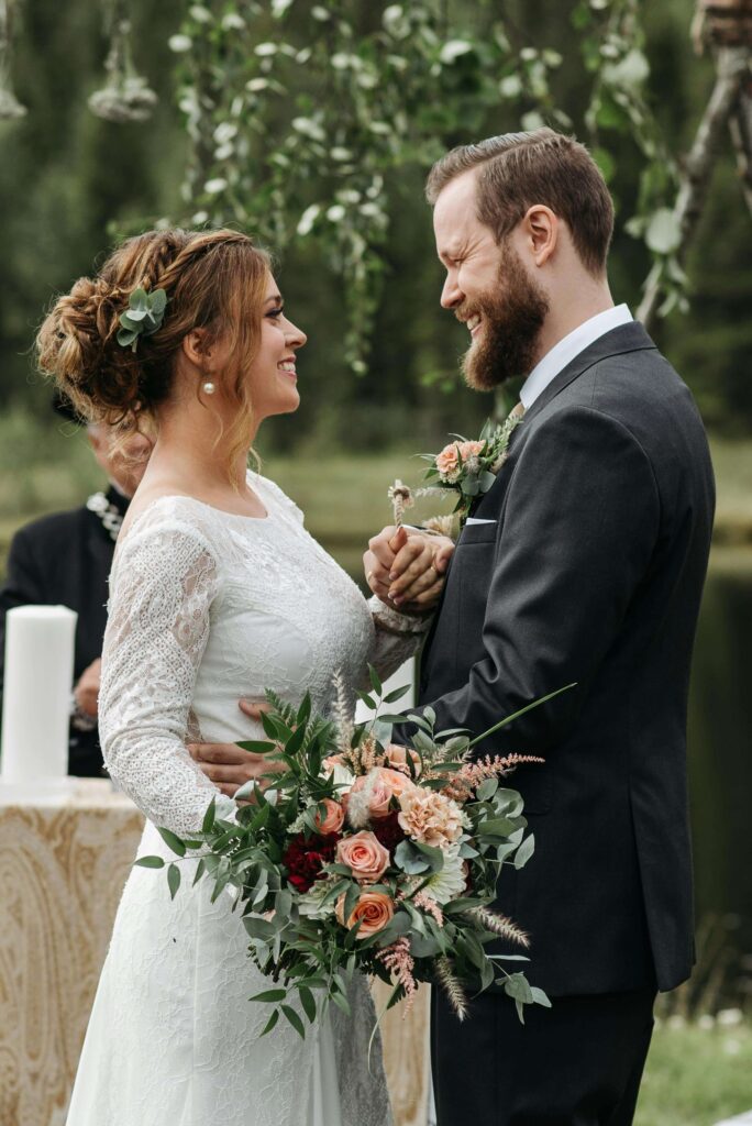 a man and woman holding hands and smiling