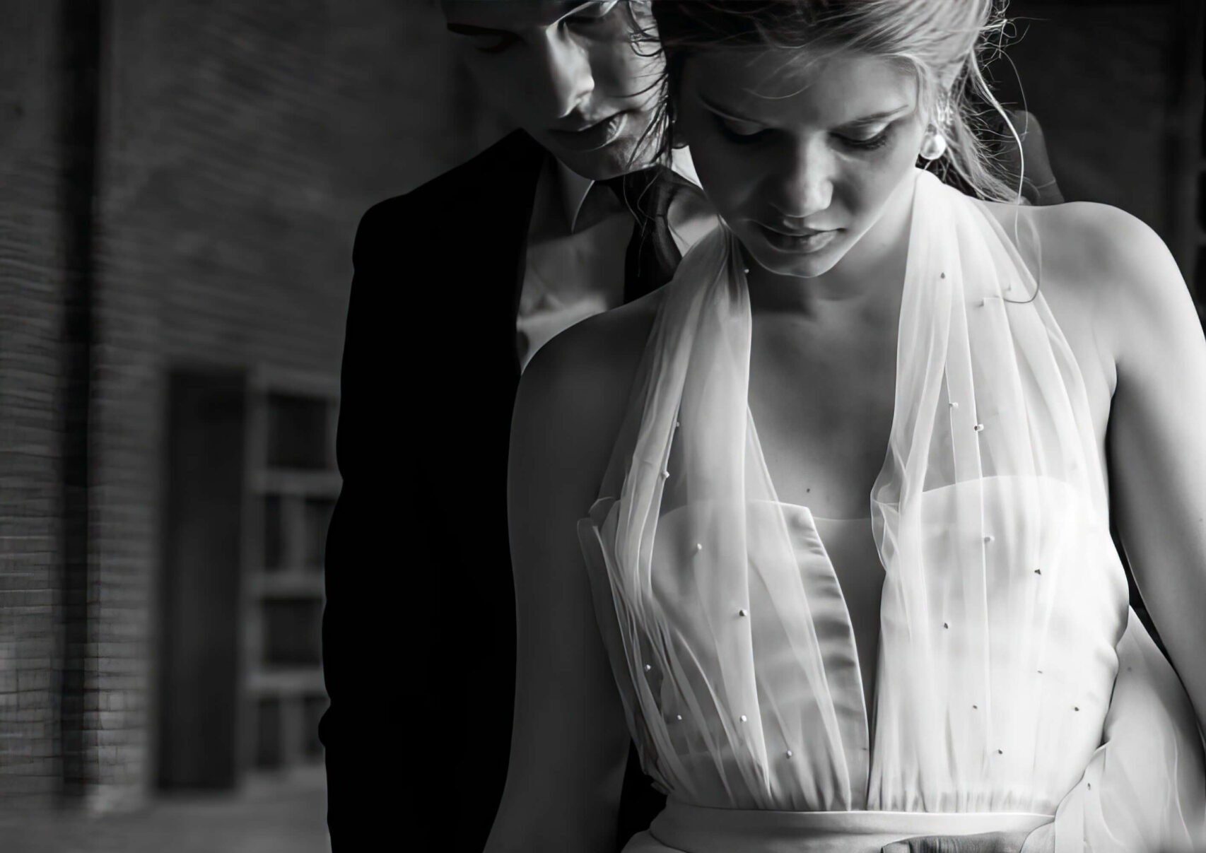 black and white photo of bride and groom, she's holding bouquet