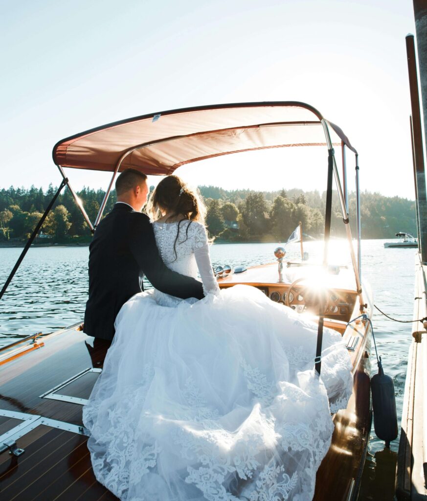 bride and groom on a boat on a lake