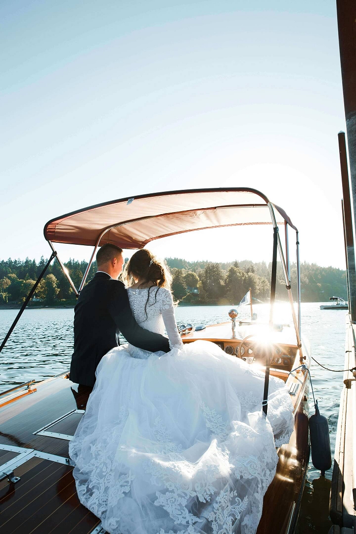 bride and groom on a boat on a lake on for wedding venues in minnesota